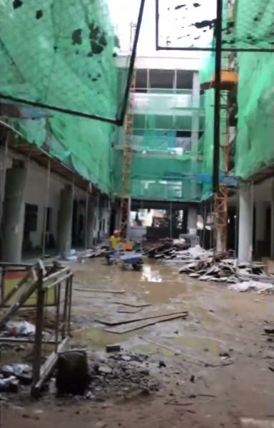 Sân Trường THCS Ngô Quyền, Tân Bình đang thi công, toà nhà phủ lưới xanh